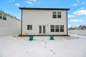 View of snow covered rear of property