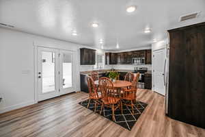 Dining room featuring sink, plenty of natural light, and light hardwood / wood-style flooring