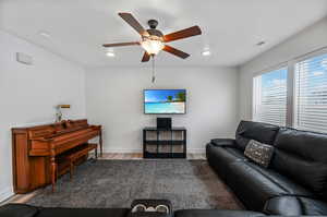 Living room with light hardwood / wood-style floors and ceiling fan