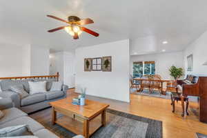 Living room featuring bamboo floors and ceiling fan