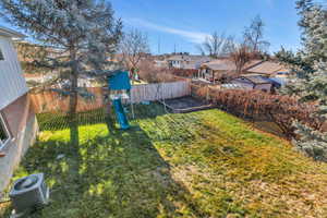 View of yard featuring a playground and central AC