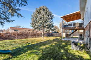 View of yard with central AC, a patio area, and a wooden deck