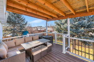 Covered deck featuring outdoor lounge area