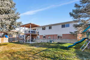 Rear view of property with a yard, a playground, a patio, and cooling unit