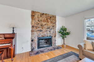 Living room with bamboo floors and a stone fireplace