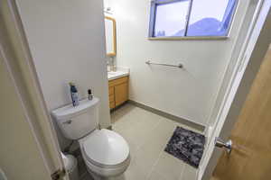 Bathroom with tile patterned floors, vanity, and toilet