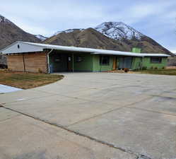 Single story home with a mountain view and a carport