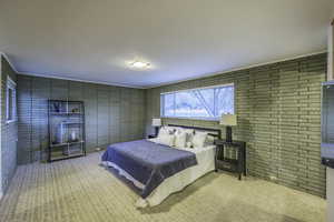 Bedroom with light carpet and ornamental molding