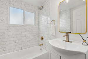 Bathroom with sink and tiled shower / bath combo