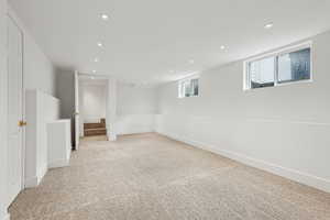 Basement with light colored carpet