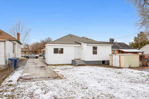 View of snow covered rear of property