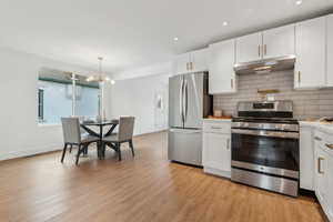 Kitchen featuring white cabinets and stainless steel appliances