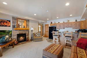 Carpeted living room featuring a gas fireplace