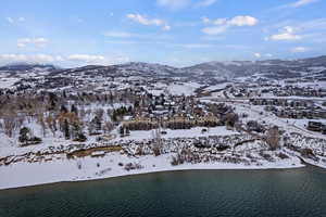 Snowy aerial view with a water and mountain view