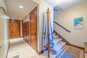 Staircase featuring carpet flooring