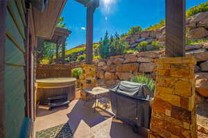 View of patio / terrace with grilling area and a hot tub