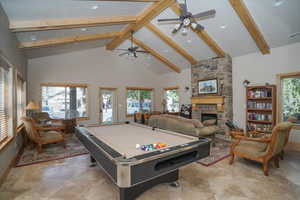 Club House Rec room featuring high vaulted ceiling, plenty of natural light, a fireplace, and billiards