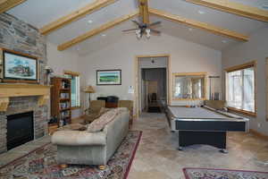 Club House Game room featuring high vaulted ceiling, a stone fireplace, billiards, ceiling fan, and beam ceiling