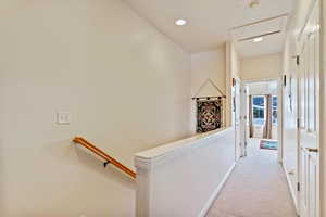 Hallway with light colored carpet