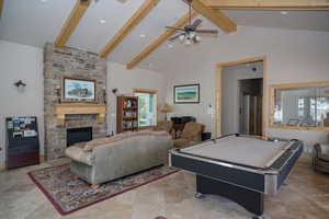 Club House Recreation room with ceiling fan, beam ceiling, high vaulted ceiling, billiards, and a stone fireplace