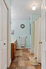 Bathroom featuring vanity and a textured ceiling