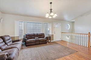 Living room featuring hardwood / wood-style flooring and an inviting chandelier