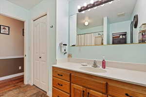 Bathroom featuring vanity, a textured ceiling, and walk in shower