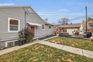 View of front of property featuring a gazebo, an outdoor hangout area, and a front lawn