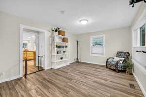 Unfurnished room with a textured ceiling and hardwood / wood-style flooring