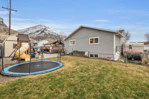 Exterior space with a mountain view, a trampoline, and a playground