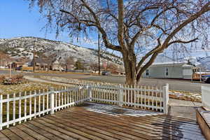 Snow covered deck with a mountain view