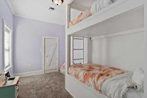 Bedroom with carpet floors and ornamental molding