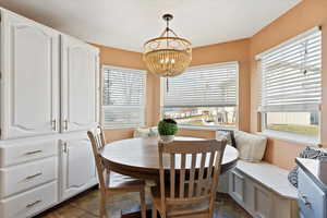 Dining area with dark tile patterned floors and breakfast area