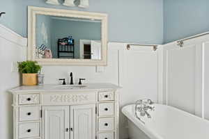 Bathroom with vanity and a bath