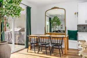 Dining space leading to patio with light hardwood / wood-style flooring