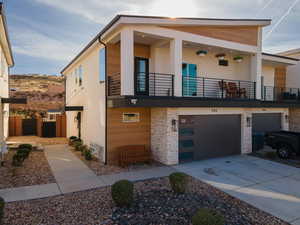 Front view featuring a balcony and a garage