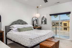 Master Bedroom with pendent lighting, carpet flooring, a mountain view, and access to exterior deck