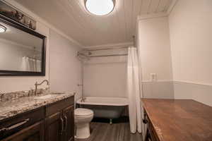 Full bathroom featuring wood ceiling, vanity, wood-type flooring, tile walls, and toilet