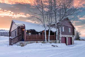 Log-style house featuring a garage