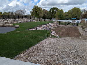 View of yard with fence and a playground