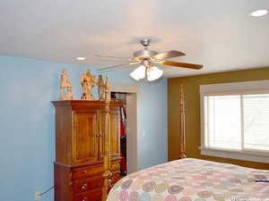 Bedroom featuring ceiling fan and a closet