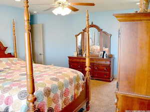 Carpeted bedroom with ceiling fan