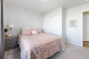 Bedroom featuring a closet and light colored carpet