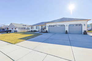 View of front of house featuring a garage and a front lawn