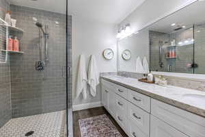 Bathroom featuring vanity and a shower with shower door