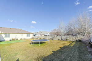 View of yard featuring a trampoline