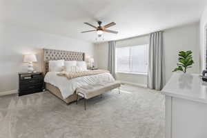 Carpeted bedroom with ceiling fan