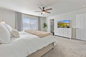 Carpeted bedroom featuring ceiling fan