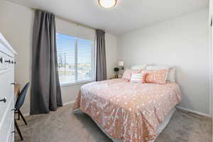 Bedroom featuring light carpet