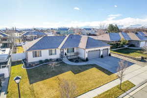 Single story home with a garage and a front yard